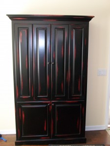 Black and red rub through T.V. cabinet